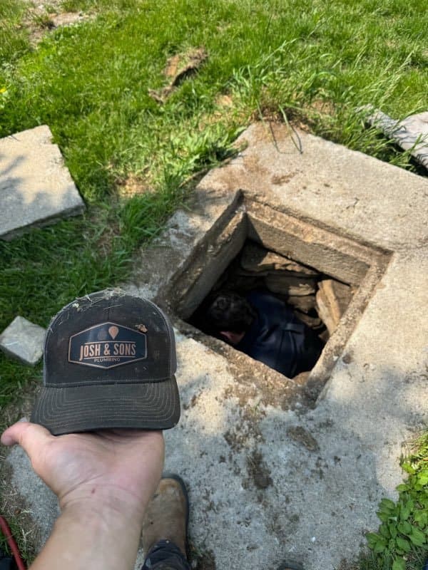 Josh & Sons cap over an access hatch on a job site